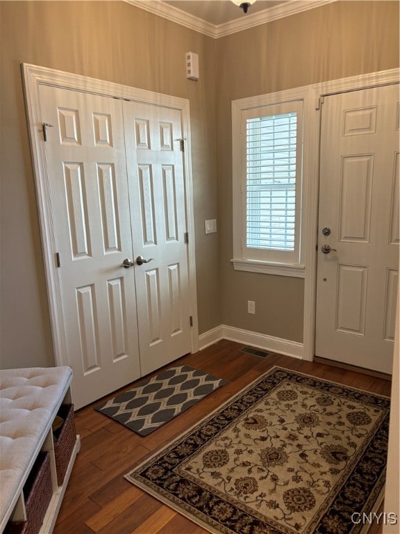 entrance foyer with crown molding and dark wood-type flooring