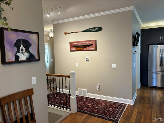 hallway with dark hardwood / wood-style flooring and ornamental molding