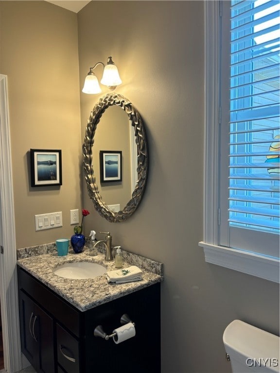 bathroom featuring vanity and toilet