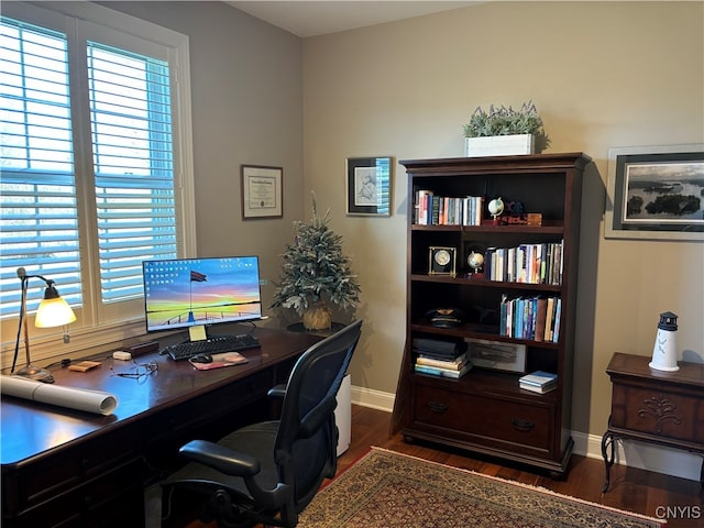 home office with dark hardwood / wood-style flooring