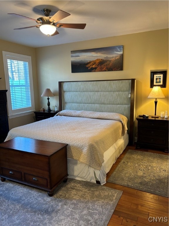 bedroom featuring ceiling fan and dark hardwood / wood-style floors