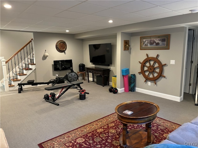 exercise area with carpet flooring and a paneled ceiling