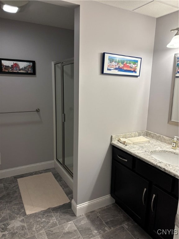 bathroom featuring vanity and a shower with door