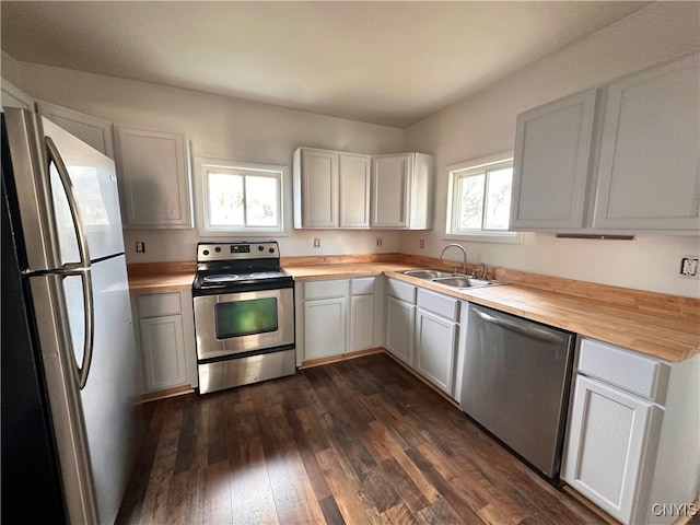 kitchen with white cabinetry, a healthy amount of sunlight, sink, and stainless steel appliances