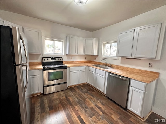 kitchen featuring sink, white cabinets, plenty of natural light, and appliances with stainless steel finishes