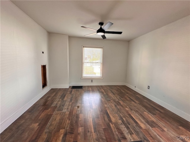 spare room featuring ceiling fan and dark wood-type flooring