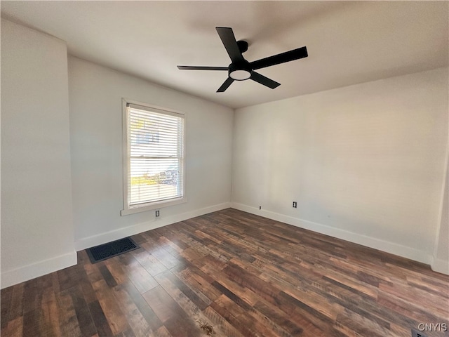 spare room with dark hardwood / wood-style floors and ceiling fan