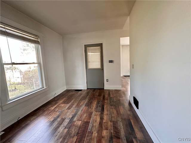 spare room with dark hardwood / wood-style flooring