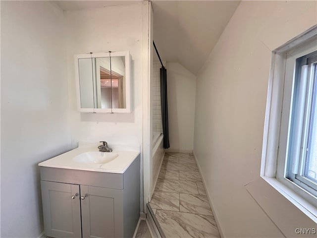 bathroom with vanity and vaulted ceiling