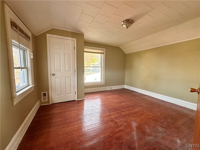 additional living space featuring dark hardwood / wood-style flooring and vaulted ceiling