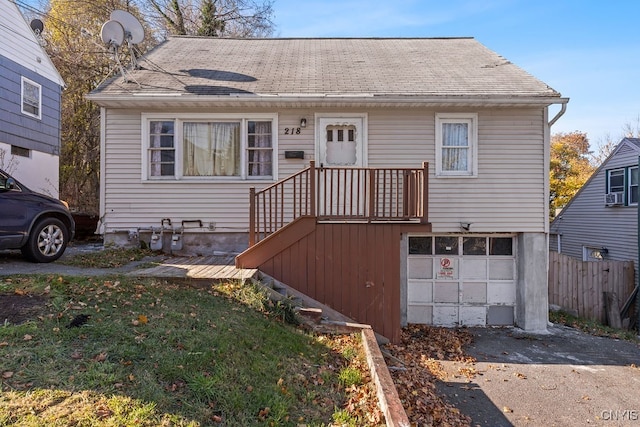 view of front of property featuring cooling unit and a garage