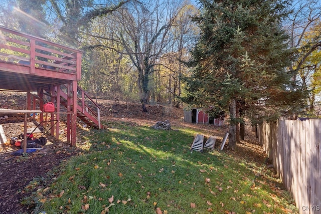 view of yard with a wooden deck and a shed