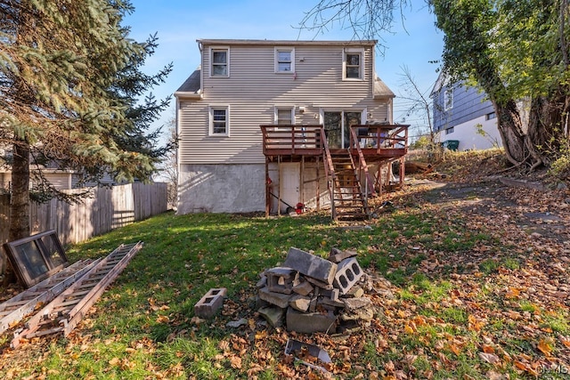 rear view of property with a deck and a lawn