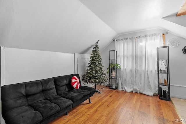 living room with light hardwood / wood-style floors and lofted ceiling