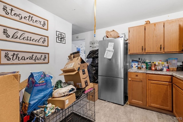 kitchen with stainless steel refrigerator and light hardwood / wood-style floors