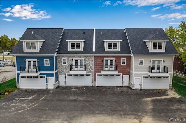 back of property featuring french doors and a balcony