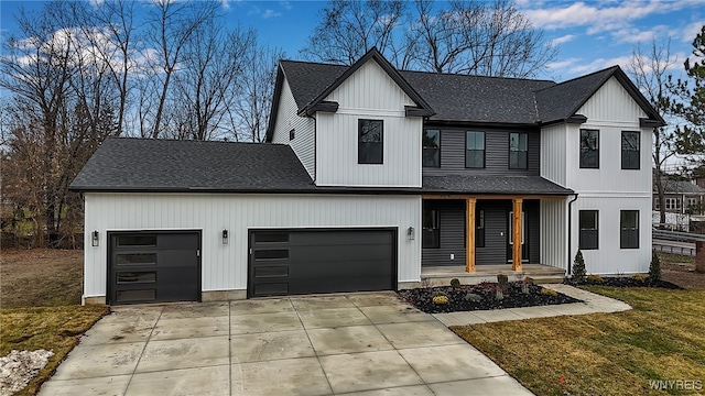 modern farmhouse with a front lawn, a porch, and a garage