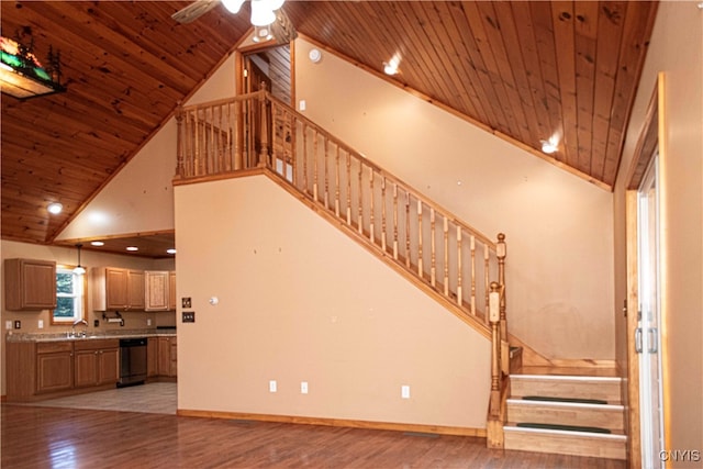 interior space featuring hardwood / wood-style floors, wood ceiling, sink, and high vaulted ceiling