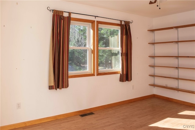 unfurnished room featuring hardwood / wood-style flooring and ceiling fan