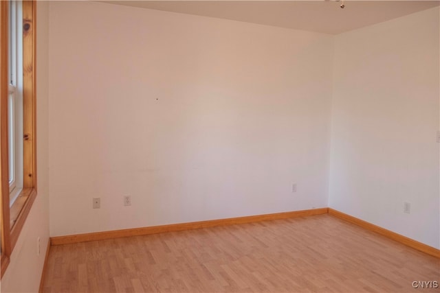 unfurnished room with light wood-type flooring