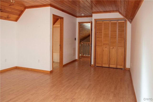 interior space with light hardwood / wood-style floors, crown molding, lofted ceiling, and wood ceiling