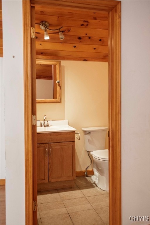 bathroom featuring tile patterned floors, vanity, wood ceiling, and toilet