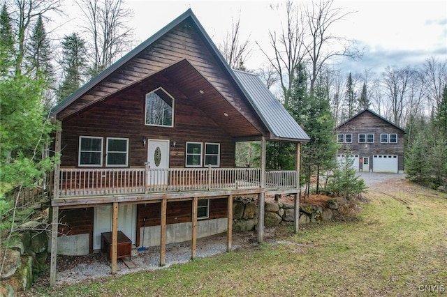 rear view of house with a lawn and a deck