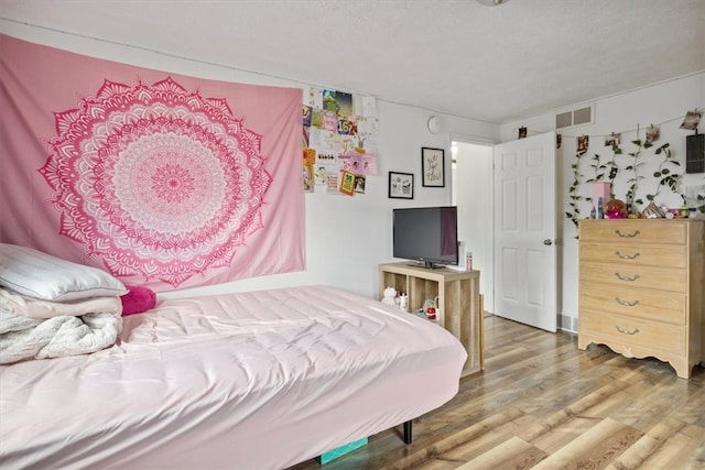 bedroom featuring hardwood / wood-style floors