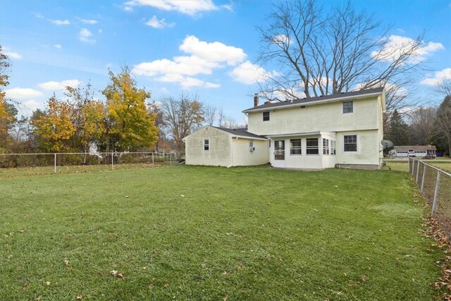 rear view of house with a yard