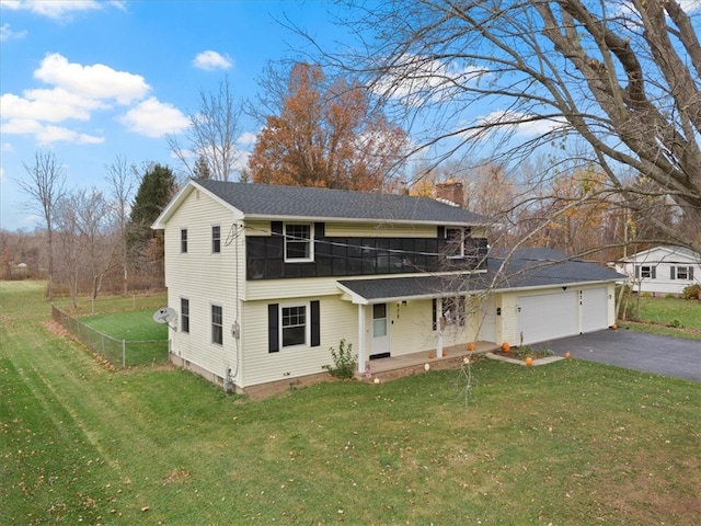 view of front property featuring a front lawn, covered porch, and a garage