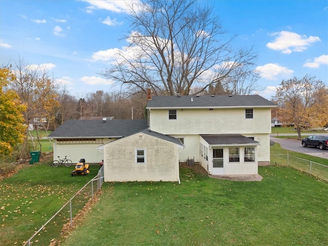 back of property featuring a lawn