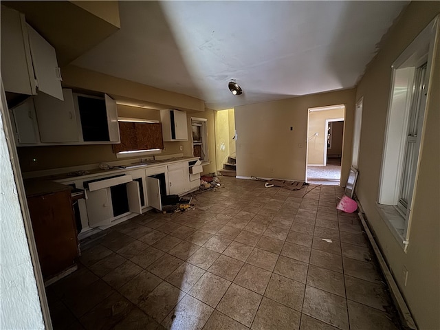 kitchen featuring white cabinets and tile patterned flooring