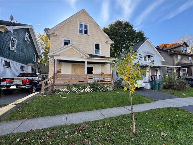 view of front facade featuring a front lawn and covered porch