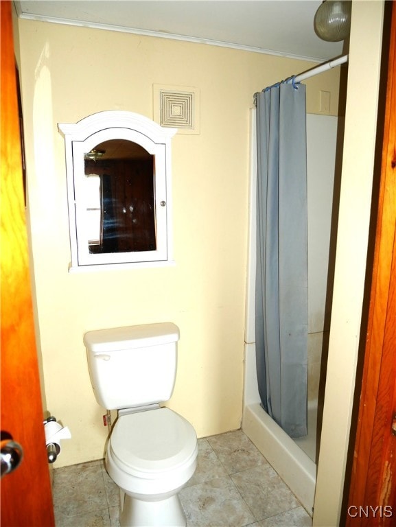 bathroom with tile patterned floors, curtained shower, and toilet