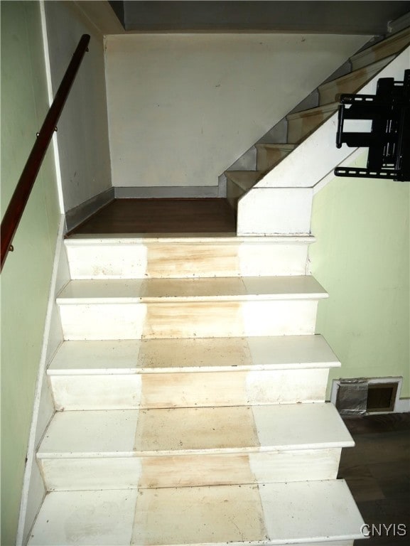 staircase with hardwood / wood-style floors