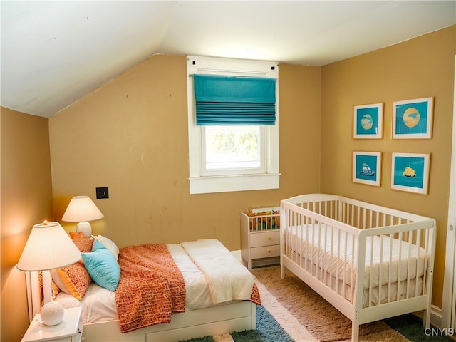 carpeted bedroom featuring lofted ceiling