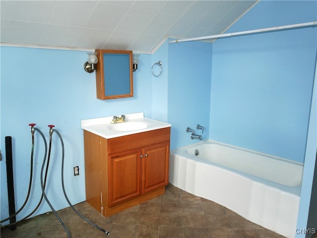 bathroom with tile patterned flooring, vanity, and a bathtub