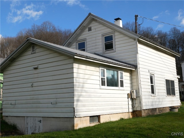 view of home's exterior with a yard