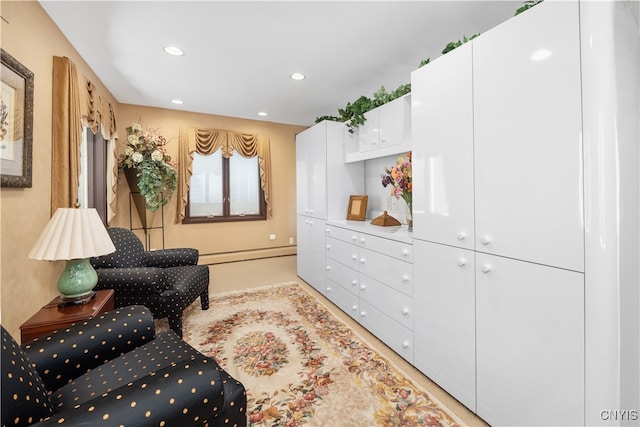 living area with a baseboard heating unit