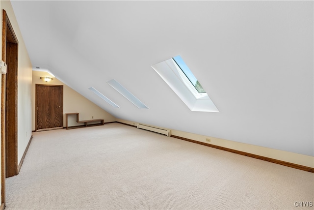 bonus room with lofted ceiling with skylight, light colored carpet, and a baseboard radiator