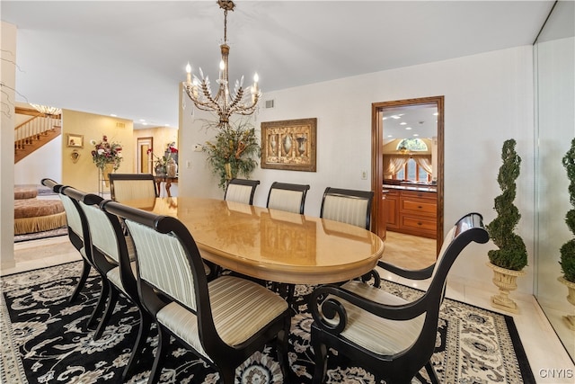 dining area featuring light tile patterned floors and a chandelier