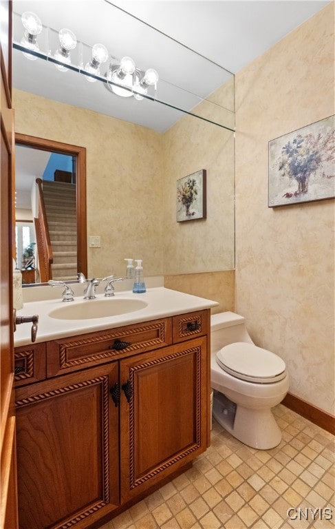 bathroom featuring tile patterned flooring, vanity, and toilet