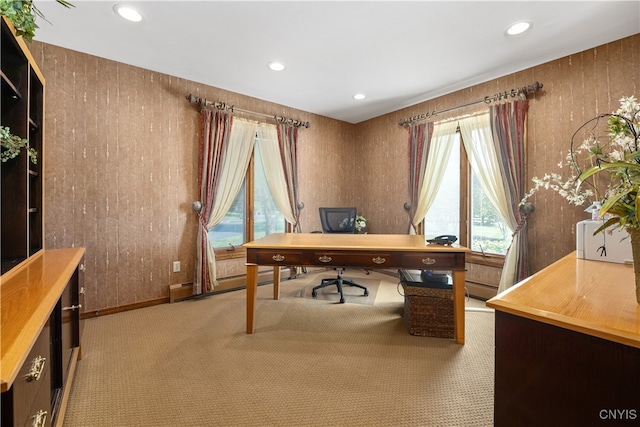 home office with baseboard heating and light carpet