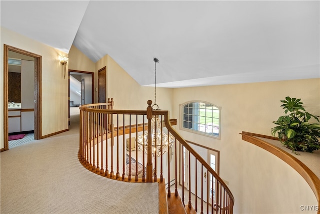 corridor featuring carpet, baseboard heating, sink, and vaulted ceiling