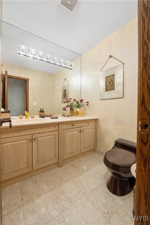 bathroom with vanity and toilet