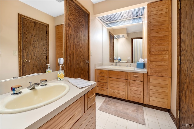 bathroom with tile patterned floors and vanity