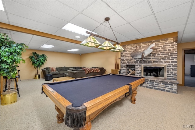 game room with a paneled ceiling, carpet floors, a fireplace, and pool table