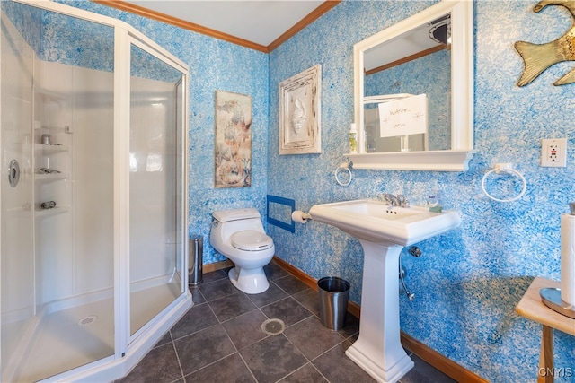 bathroom with toilet, tile patterned floors, a shower with shower door, and crown molding