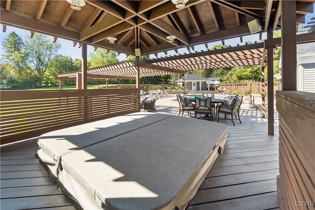 wooden terrace featuring a pergola and a hot tub