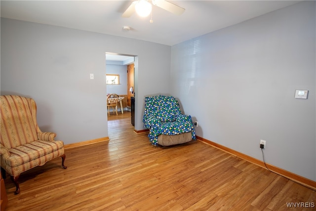 sitting room featuring ceiling fan and light hardwood / wood-style floors